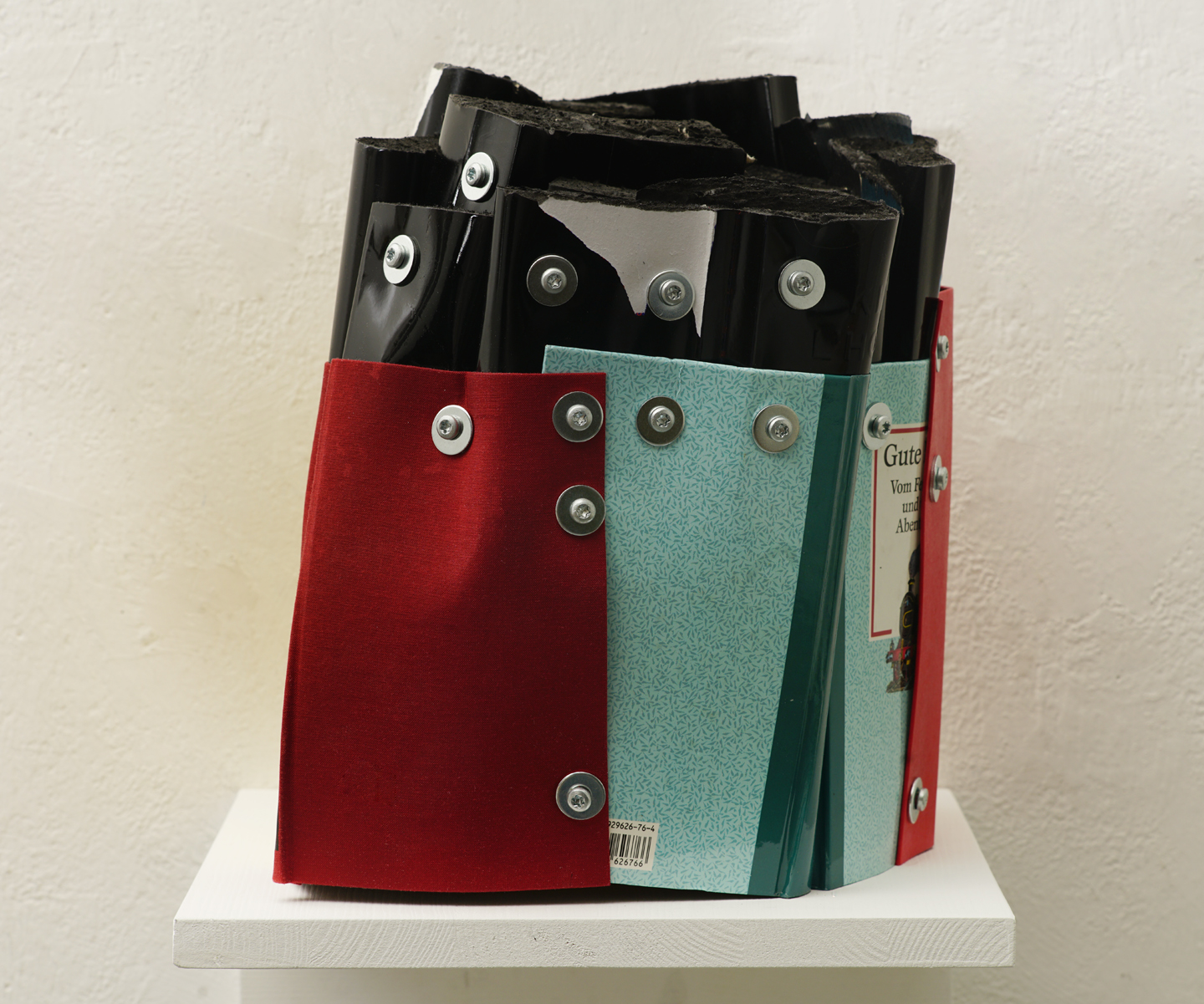 The Family Guest, cut books (varnished black), book covers, screws, app.: 30 x 35 x 26 cm, 2025